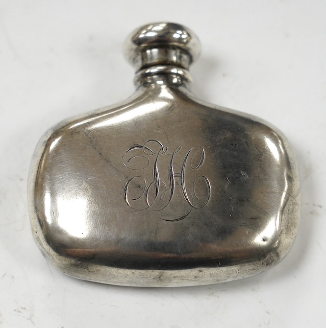 A late Victorian small silver hip flask, by Saunders & Shepherd, Birmingham, 1900, width 62mm. Condition - poor to fair